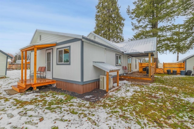 snow covered property featuring a deck