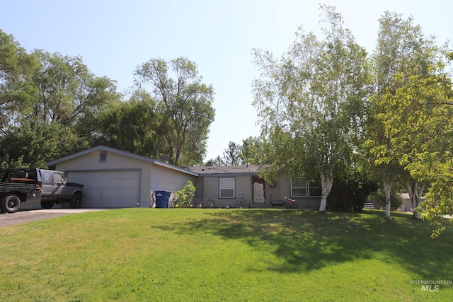 ranch-style home featuring an attached garage, a front yard, and driveway