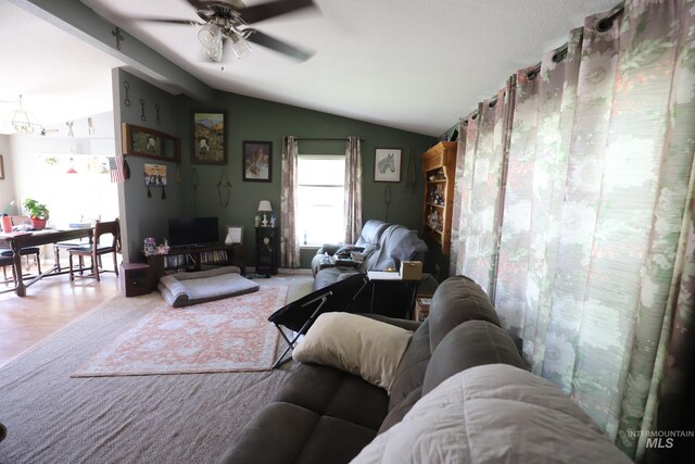 living room featuring vaulted ceiling and a ceiling fan