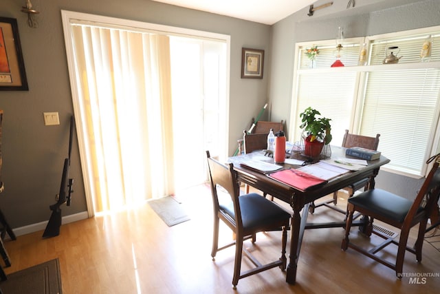 dining room with light wood-type flooring and baseboards
