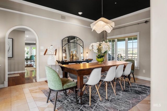 176 Marine View Dr, Lewiston, ID 83501 - dining area featuring tile patterned floors, plenty of natural light, crown molding, arched walkways, and baseboards