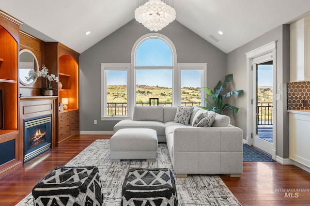 176 Marine View Dr, Lewiston, ID 83501 - living area with a glass covered fireplace, dark wood-style flooring, baseboards, and high vaulted ceiling