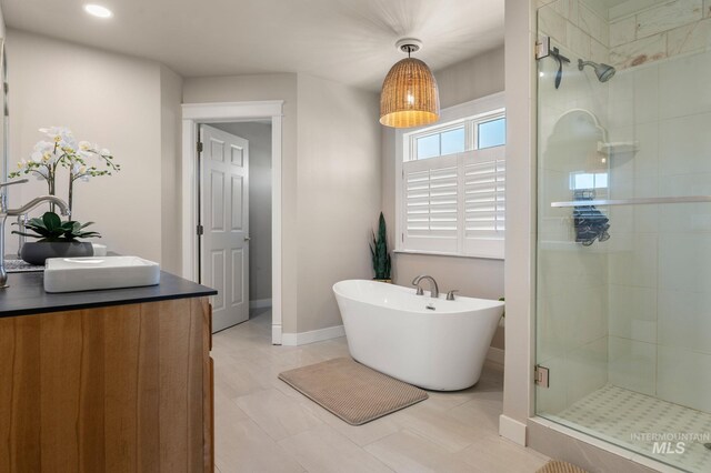 176 Marine View Dr, Lewiston, ID 83501 - full bath with a shower stall, a freestanding tub, baseboards, and recessed lighting