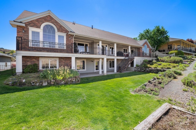 176 Marine View Dr, Lewiston, ID 83501 - rear view of property featuring brick siding, a patio, a yard, and stairway