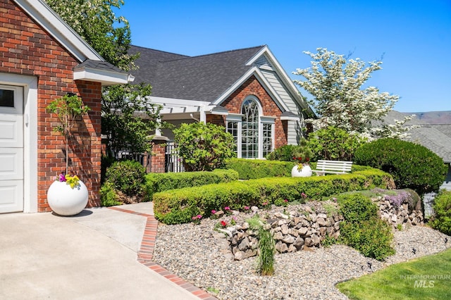 176 Marine View Dr, Lewiston, ID 83501 - view of side of property featuring brick siding, roof with shingles, and a garage