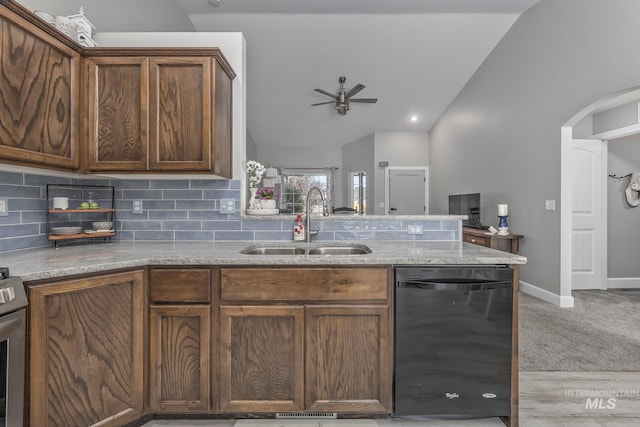 kitchen featuring arched walkways, a sink, lofted ceiling, a ceiling fan, and dishwasher