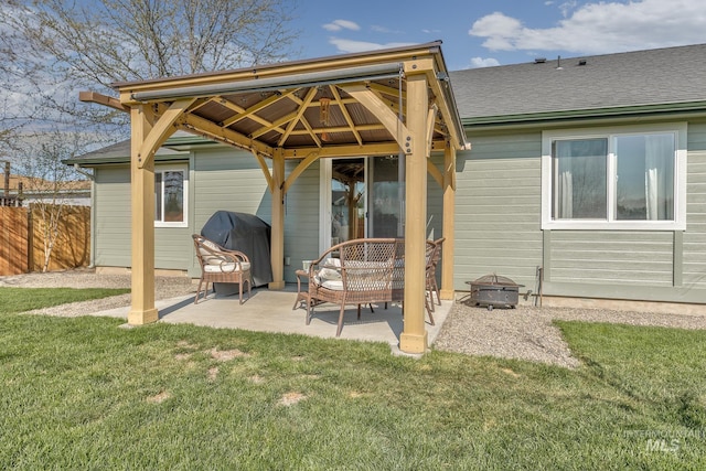 back of house with a lawn, a gazebo, fence, and an outdoor fire pit