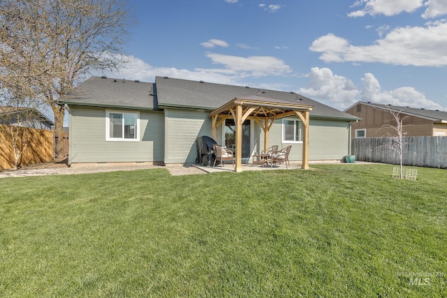 rear view of house with a fenced backyard, a gazebo, a yard, and a patio