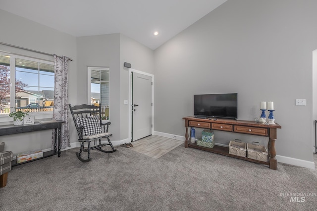 living area with high vaulted ceiling, carpet flooring, baseboards, and recessed lighting