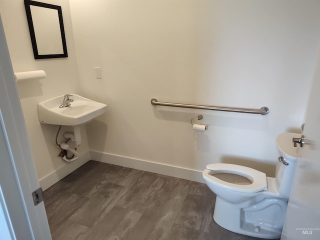 1018 S Washington Ave, Emmett, ID 83617 - bathroom featuring hardwood / wood-style floors, toilet, and sink