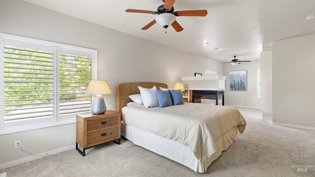 bedroom with light carpet, multiple windows, baseboards, and ceiling fan