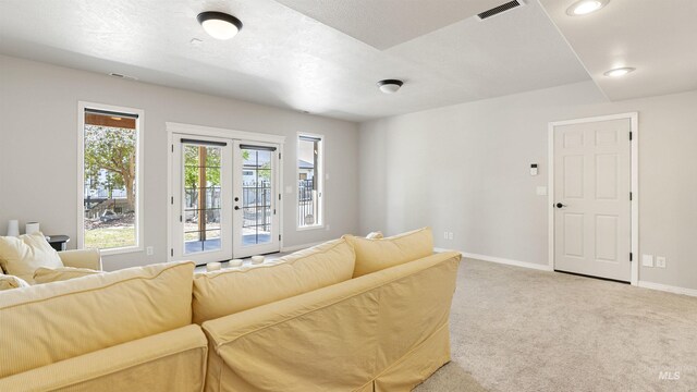 carpeted living room featuring french doors, baseboards, and recessed lighting