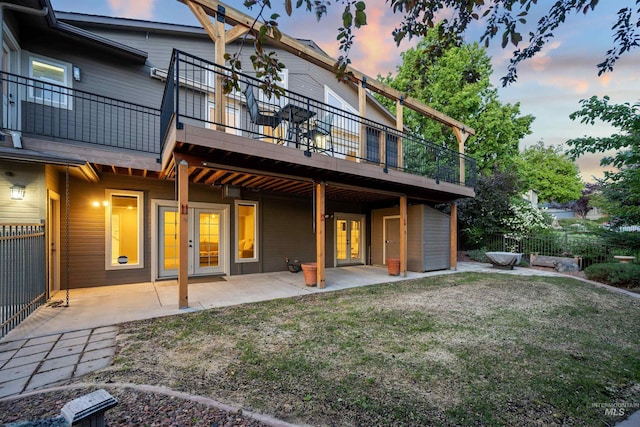 rear view of house featuring a patio area, french doors, and a wooden deck