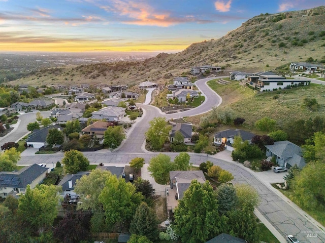 aerial view of property and surrounding area with nearby suburban area and a mountain backdrop