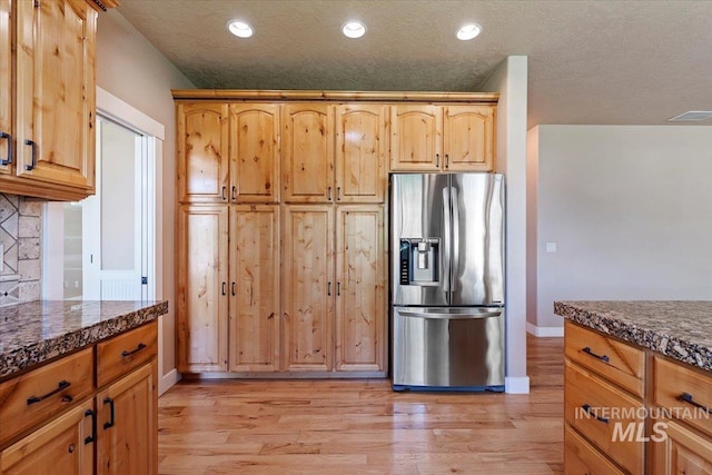 1112 W Belknap Dr, Nampa, ID 83686 - kitchen featuring stainless steel refrigerator with ice dispenser, light wood finished floors, recessed lighting, a textured ceiling, and backsplash