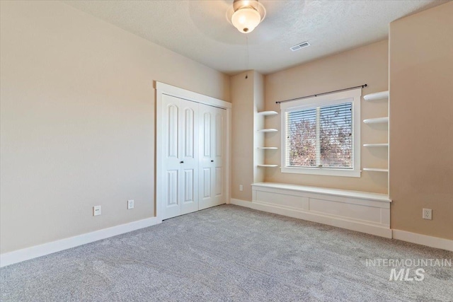 1112 W Belknap Dr, Nampa, ID 83686 - unfurnished bedroom featuring carpet, a closet, a textured ceiling, and a ceiling fan