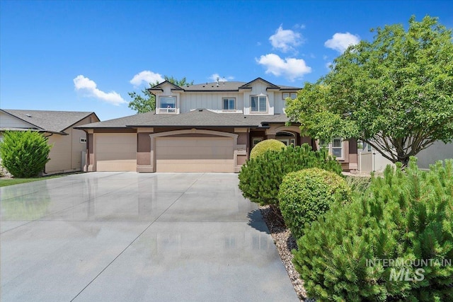 1112 W Belknap Dr, Nampa, ID 83686 - view of front of house with concrete driveway, an attached garage, and stucco siding