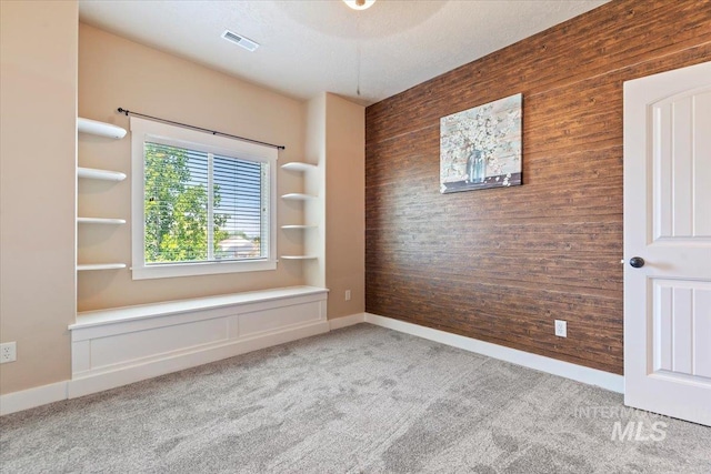 1112 W Belknap Dr, Nampa, ID 83686 - carpeted spare room with wooden walls and an accent wall