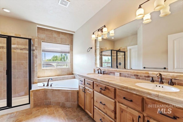1112 W Belknap Dr, Nampa, ID 83686 - full bathroom featuring a shower stall, plenty of natural light, a bath, and double vanity