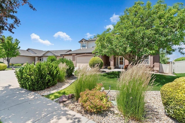 1112 W Belknap Dr, Nampa, ID 83686 - view of property hidden behind natural elements featuring a garage and stucco siding