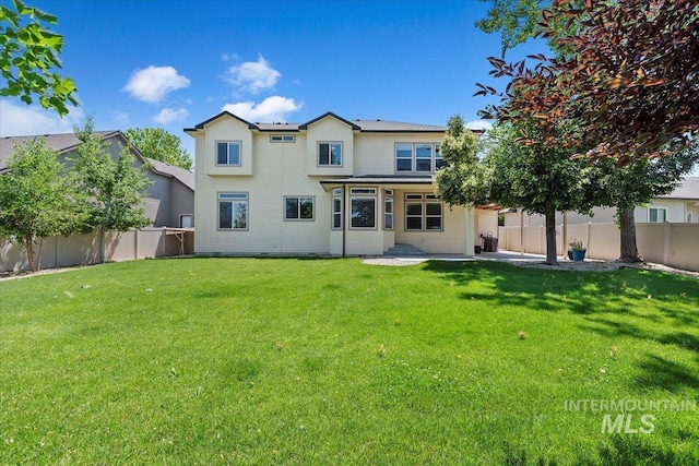 1112 W Belknap Dr, Nampa, ID 83686 - back of property featuring a fenced backyard and a patio
