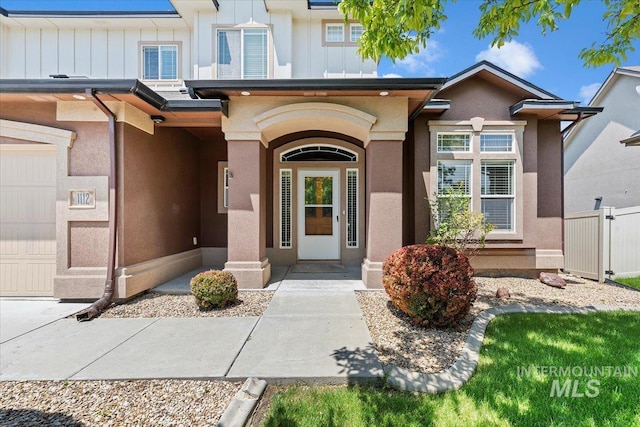 1112 W Belknap Dr, Nampa, ID 83686 - property entrance featuring board and batten siding, a garage, and stucco siding