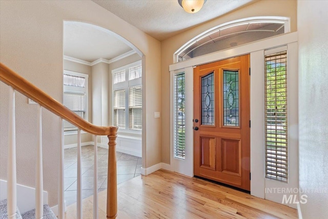 1112 W Belknap Dr, Nampa, ID 83686 - foyer featuring arched walkways, stairway, ornamental molding, and wood finished floors