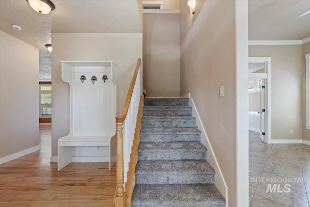 1112 W Belknap Dr, Nampa, ID 83686 - stairs with a textured ceiling, crown molding, and wood finished floors
