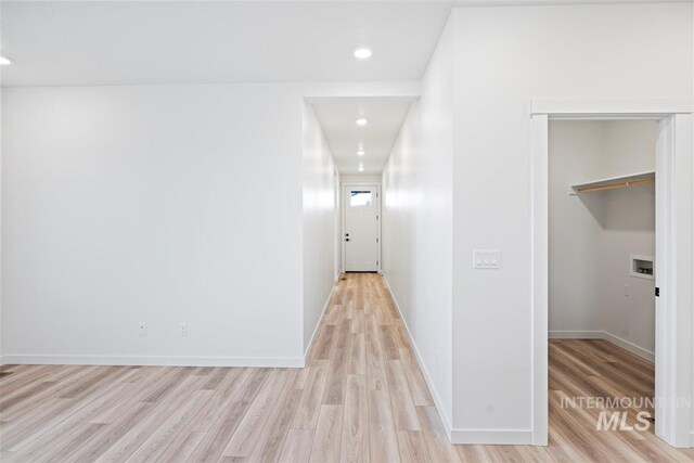 corridor with light hardwood / wood-style flooring