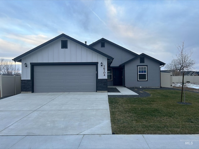 12386 Cole Ridge St, Caldwell, ID 83607 - view of front of house with a garage and a front lawn