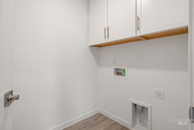 laundry area with electric dryer hookup, light wood-type flooring, washer hookup, cabinet space, and baseboards