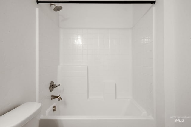 bathroom with shower / washtub combination and toilet