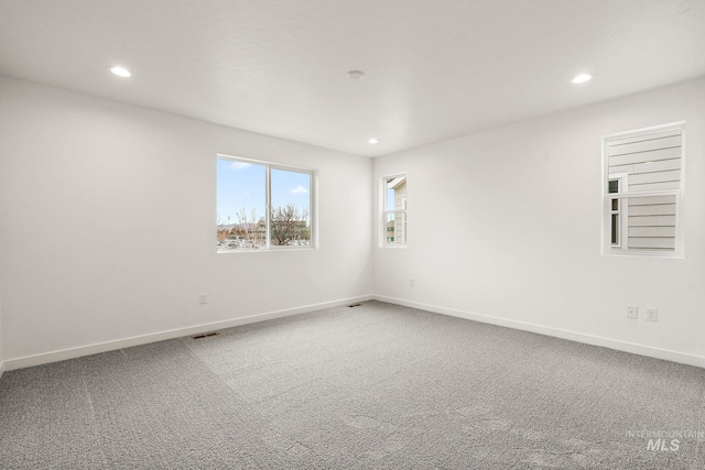 spare room with carpet flooring and baseboards