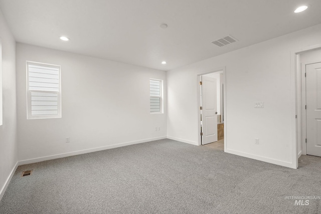 unfurnished bedroom featuring recessed lighting, visible vents, and carpet