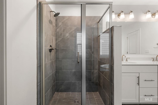 full bathroom with a shower stall and vanity