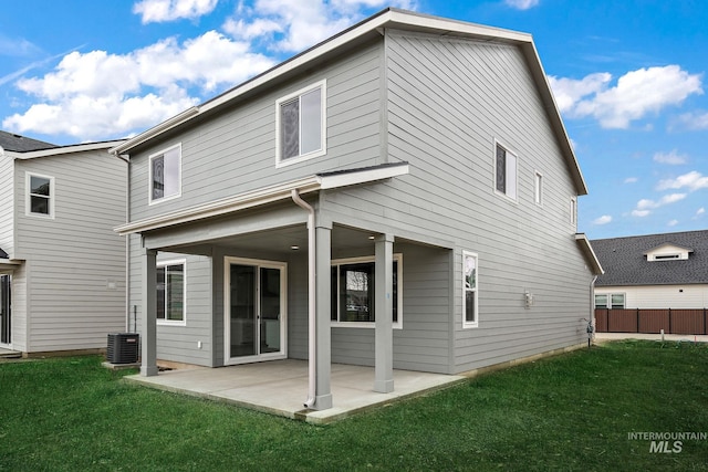 back of property featuring a yard, a patio, and central AC