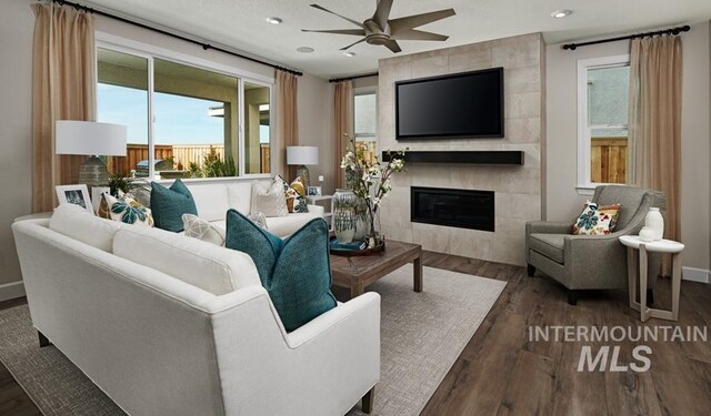 living area with wood finished floors, baseboards, a fireplace, recessed lighting, and ceiling fan
