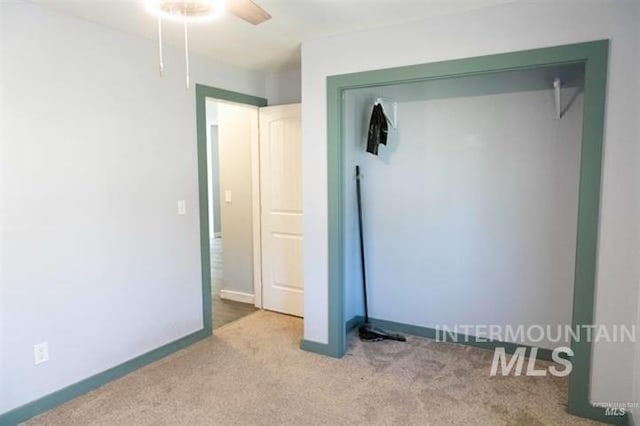 unfurnished bedroom with light carpet and ceiling fan