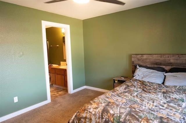 bedroom with carpet flooring, ensuite bathroom, and ceiling fan