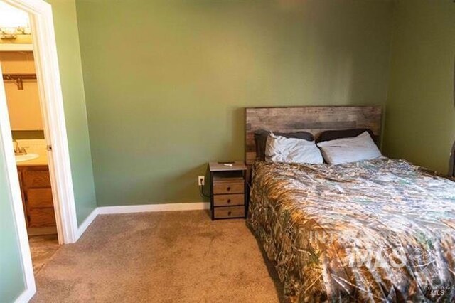 carpeted bedroom with connected bathroom