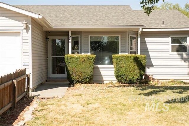 doorway to property with a yard