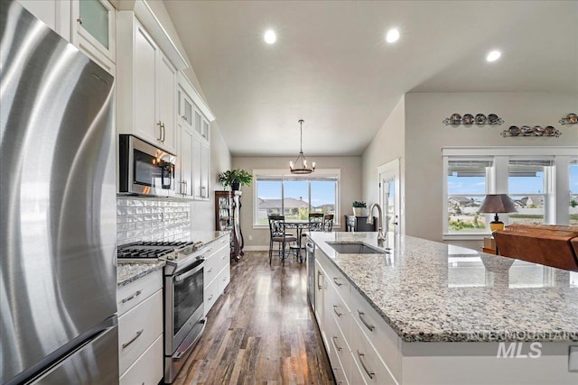 3492 E 3600 N, Kimberly, ID 83341 - kitchen featuring appliances with stainless steel finishes, a sink, dark wood-style flooring, an island with sink, and decorative backsplash
