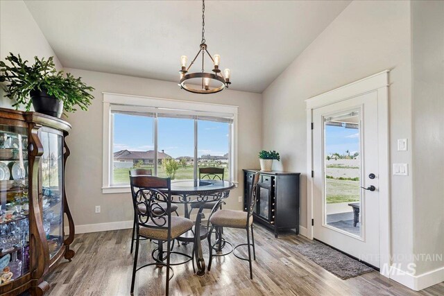 3492 E 3600 N, Kimberly, ID 83341 - dining area with a chandelier, wood finished floors, vaulted ceiling, and baseboards