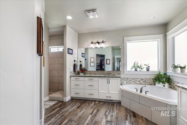 3492 E 3600 N, Kimberly, ID 83341 - bathroom featuring wood finished floors, tiled shower, a bath, vanity, and recessed lighting