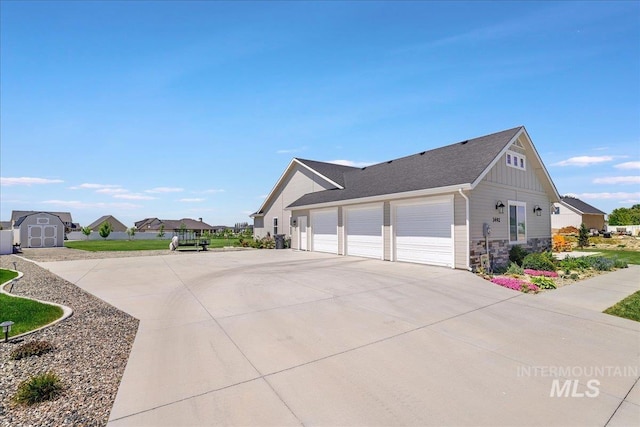 3492 E 3600 N, Kimberly, ID 83341 - view of side of property featuring driveway, a garage, board and batten siding, and stone siding