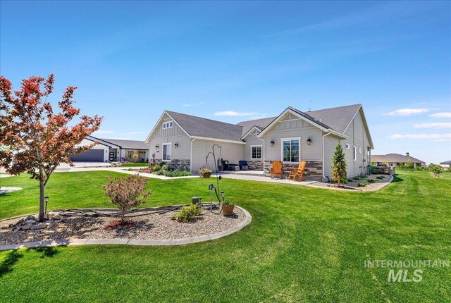 3492 E 3600 N, Kimberly, ID 83341 - rear view of property featuring board and batten siding, a lawn, a patio, a garage, and stone siding