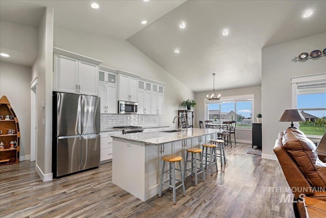 3492 E 3600 N, Kimberly, ID 83341 - kitchen featuring stainless steel appliances, a sink, wood finished floors, a center island with sink, and tasteful backsplash