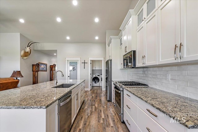3492 E 3600 N, Kimberly, ID 83341 - kitchen featuring appliances with stainless steel finishes, a sink, washer / dryer, dark wood-type flooring, and white cabinets