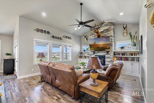 3492 E 3600 N, Kimberly, ID 83341 - living area featuring a ceiling fan, a stone fireplace, wood finished floors, vaulted ceiling, and baseboards