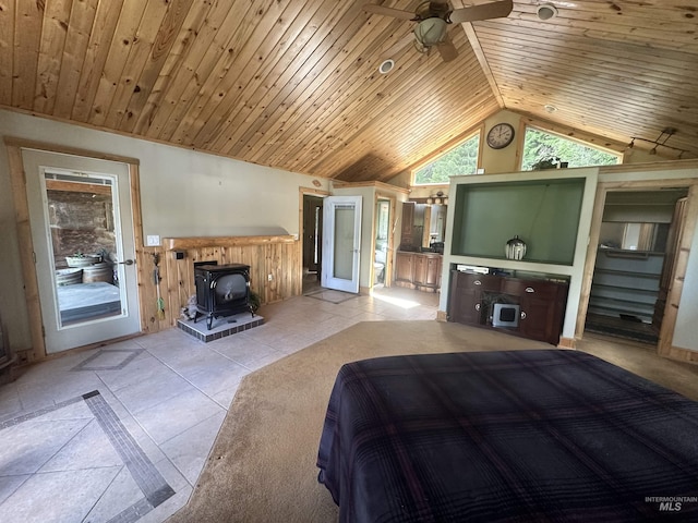 2223 Glenwood Rd, Kamiah, ID 83536 - bedroom featuring light tile patterned floors, a wood stove, high vaulted ceiling, and wooden ceiling